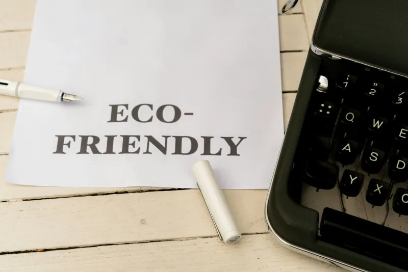 ECO-FRIENDLY business planning note with classic typewriter, representing enduring corporate responsibility values integrated into core operations