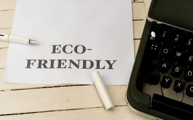 ECO-FRIENDLY business planning note with classic typewriter, representing enduring corporate responsibility values integrated into core operations