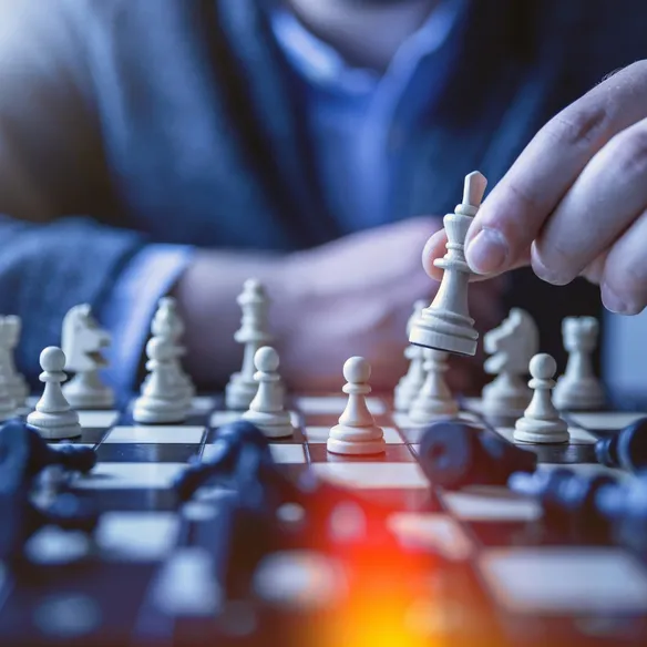Business professional making strategic chess move, representing thoughtful AI strategy planning