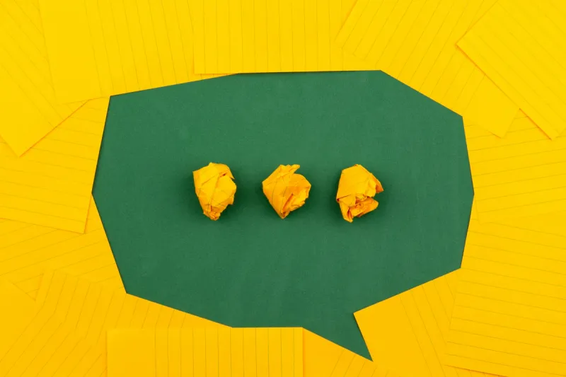 Crumpled paper in speech bubble representing AI-generated communication losing human authenticity