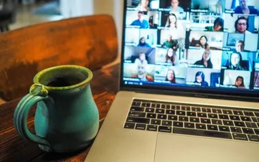 Laptop displaying a video conference call with multiple participants in a grid layout, representing the daily reality of remote team communication challenges