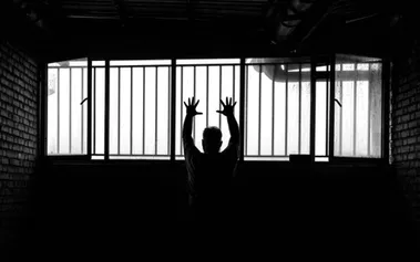 Silhouette of person behind prison bars, symbolising how technical expertise can become a career trap