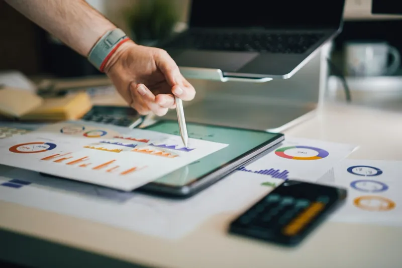 Professional using stylus on tablet with business intelligence, showing superagency leaders blending AI insights with human strategic thinking