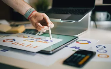 Professional using stylus on tablet with business intelligence, showing superagency leaders blending AI insights with human strategic thinking