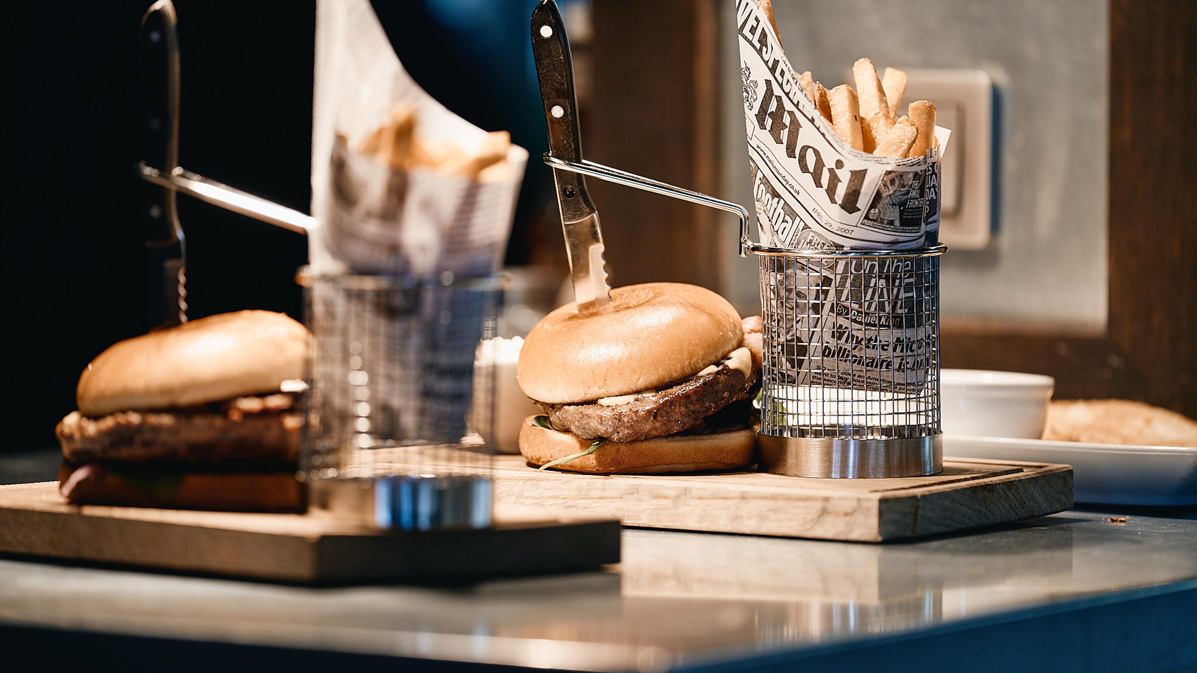Hamburgers and fries that are ready to be served to guests in the restaurant.