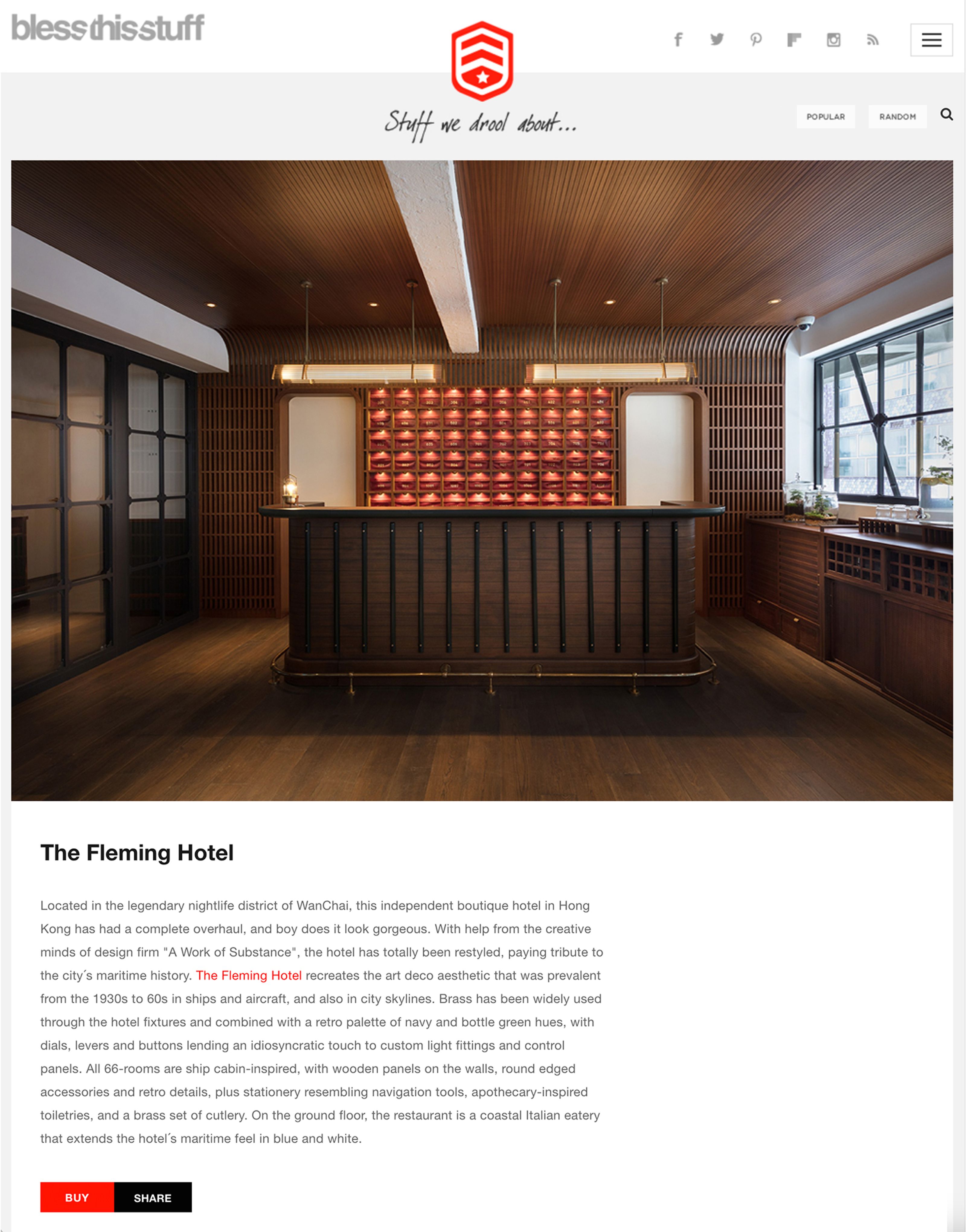 The Fleming Hotel reception area with a dark wooden desk and a backlit wall of red cubbies.