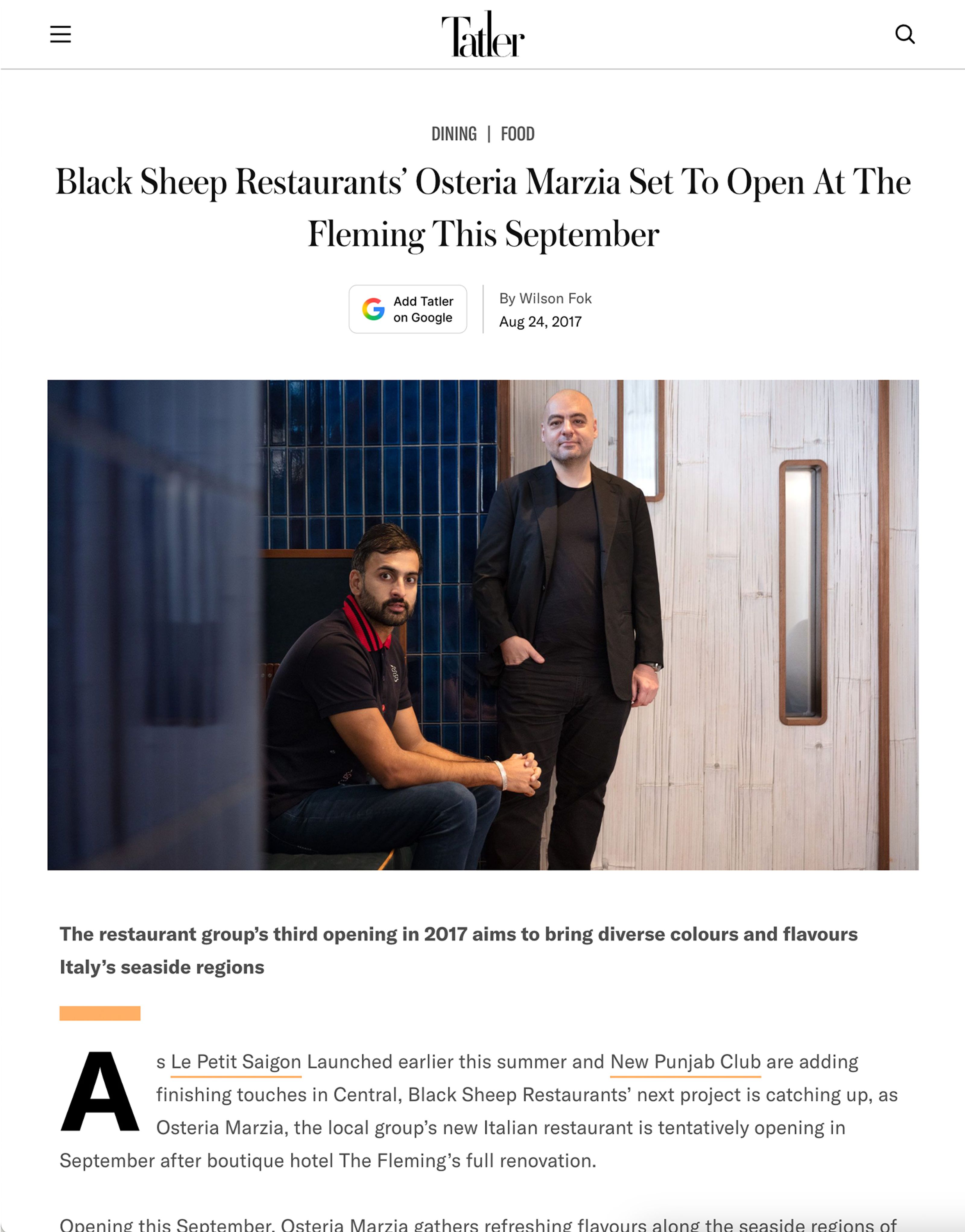 Two men, founders of Black Sheep Restaurants, posing in a modern restaurant interior.