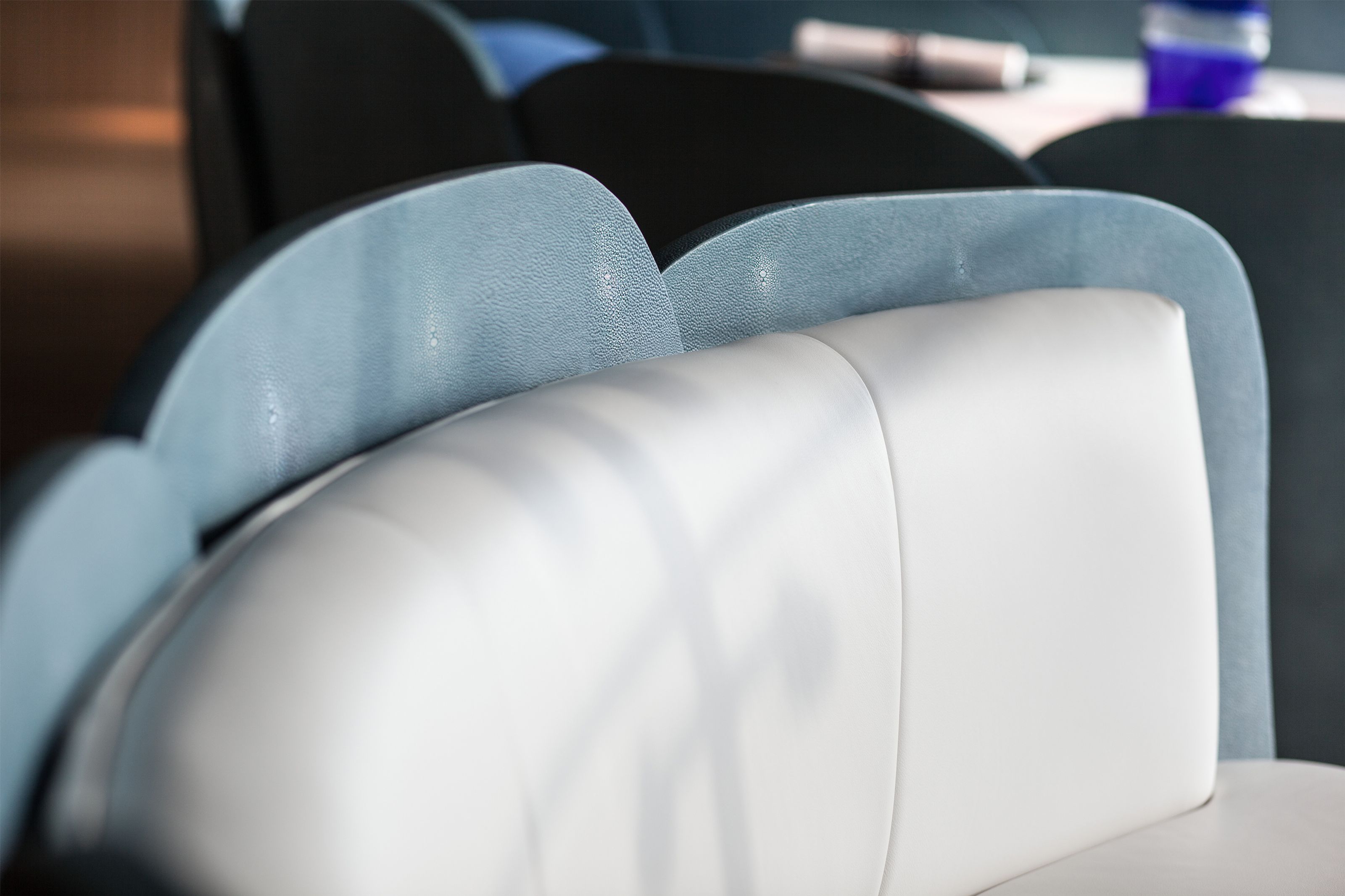 White cushioned seating with light blue scalloped backs.