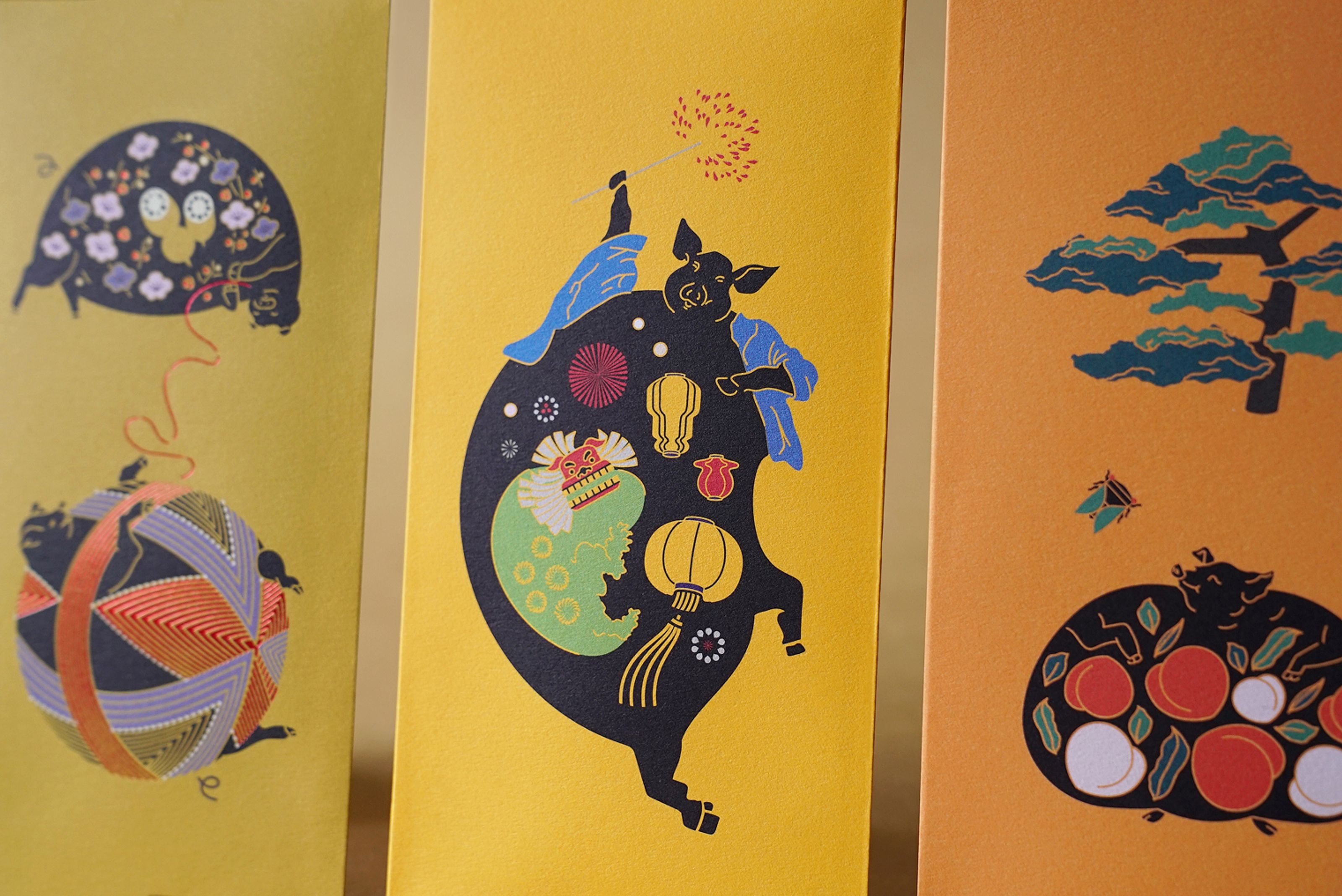 Three vibrant art cards depicting stylized pigs with traditional festive designs.
