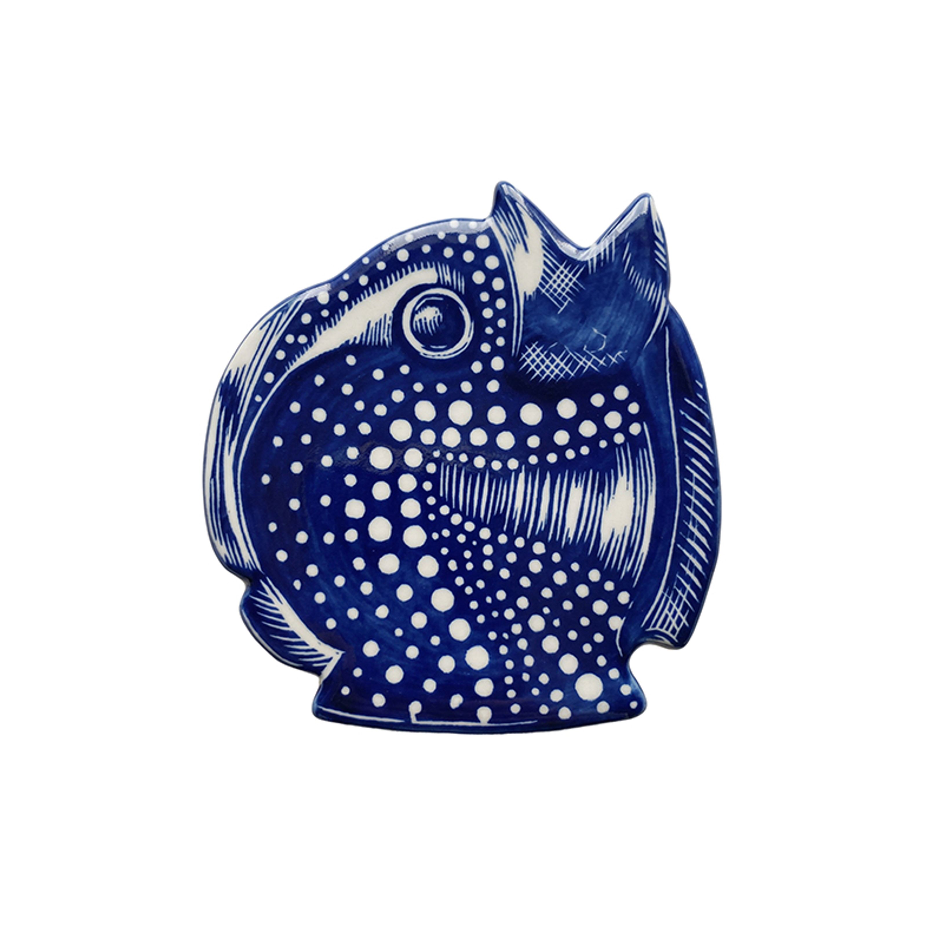 A blue and white fish-shaped decorative plate with polka dot and striped patterns.