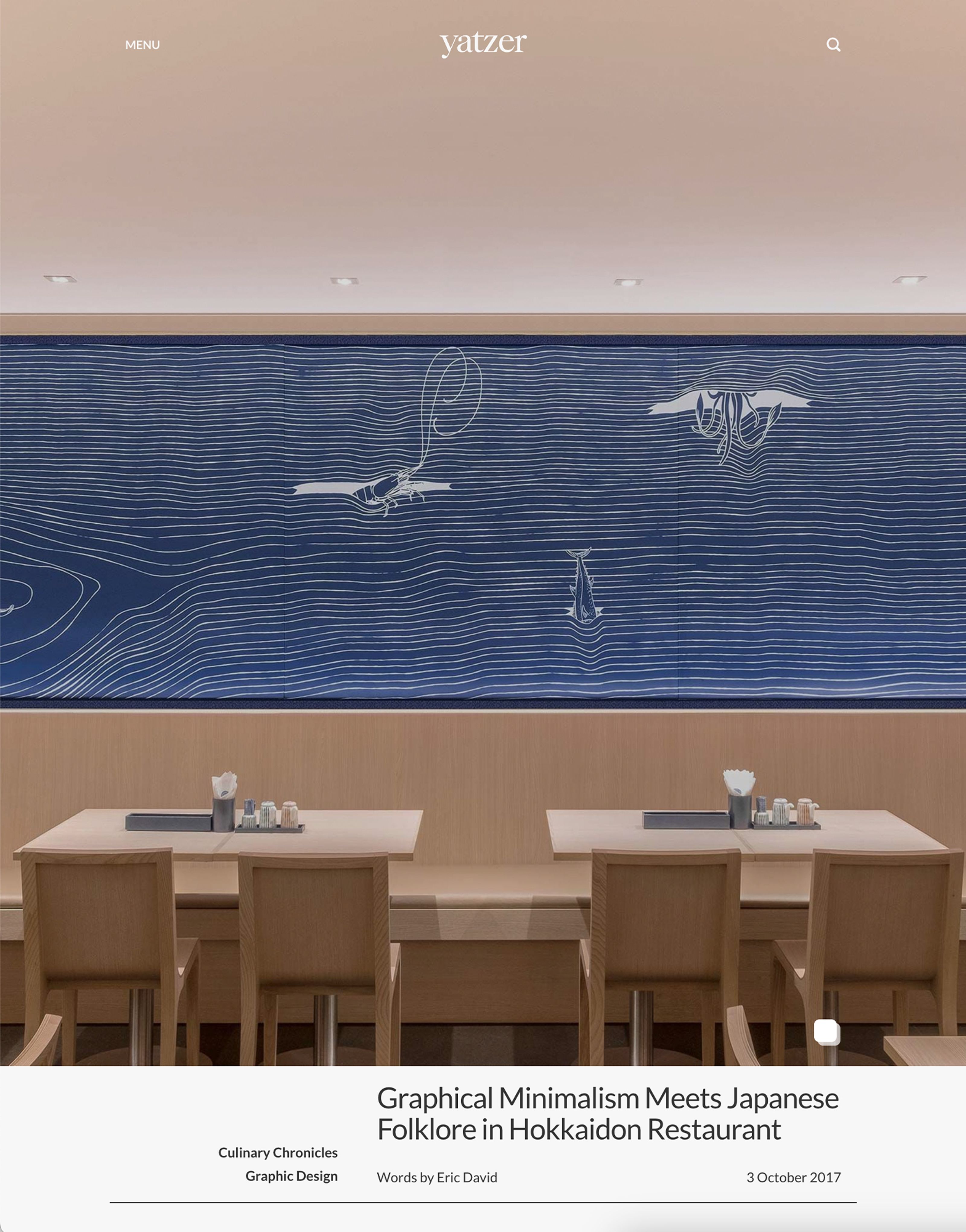 Minimalist restaurant interior with light wood furniture and a blue mural featuring stylized Japanese marine life.