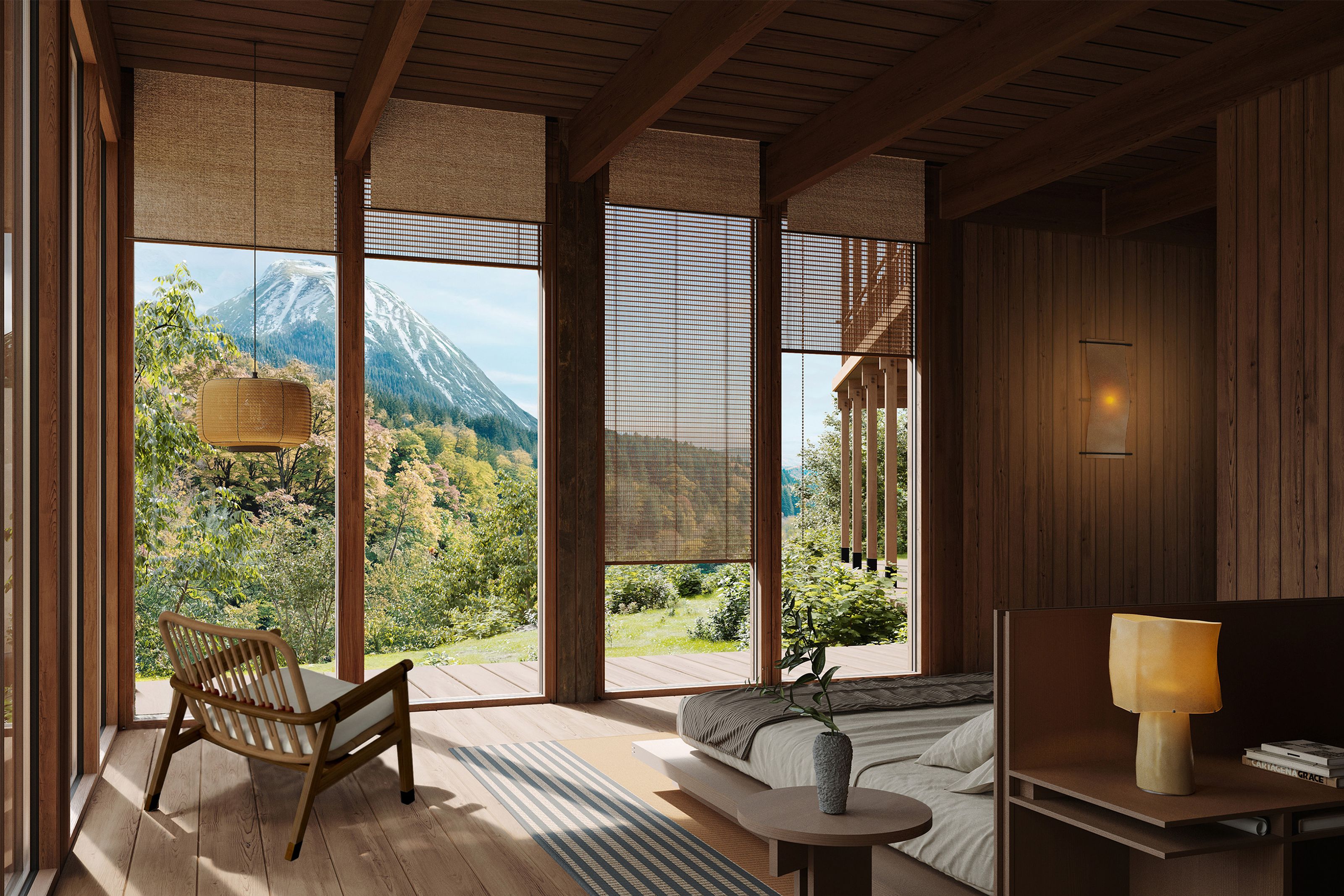 Rustic wooden room with large windows overlooking a lush mountain landscape, featuring a bed, chair, and woven blinds.