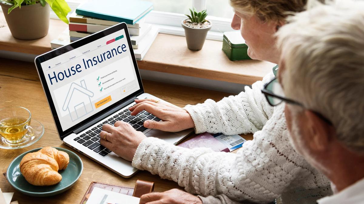 Senior couple consulting house insurance