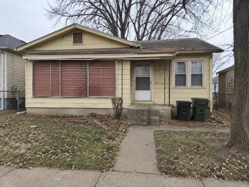 A small bungalow with an enclosed front porch, sold exactly as it stands