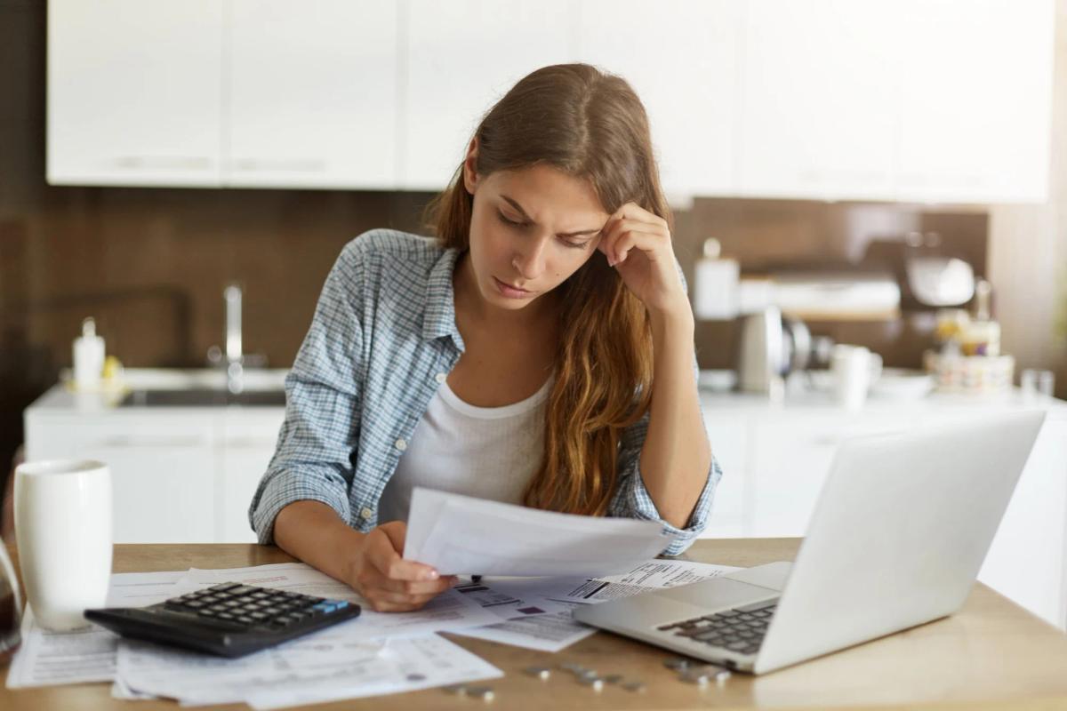 Young woman checking her budget and doing taxes
