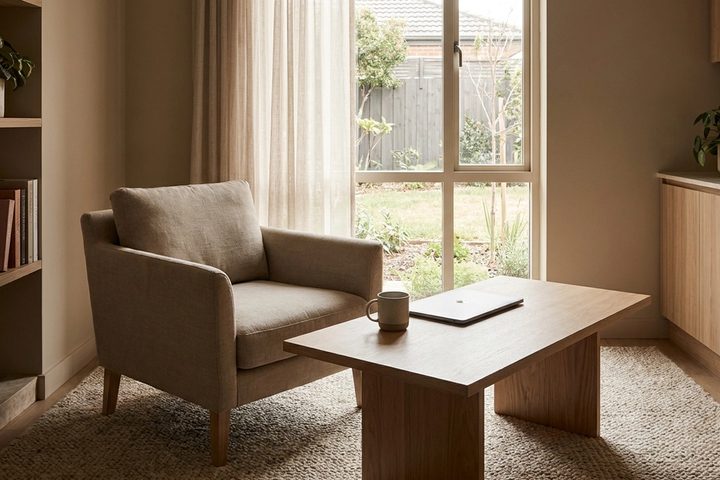 Quiet modern clinic consultation room with an empty chair and closed laptop in daylight