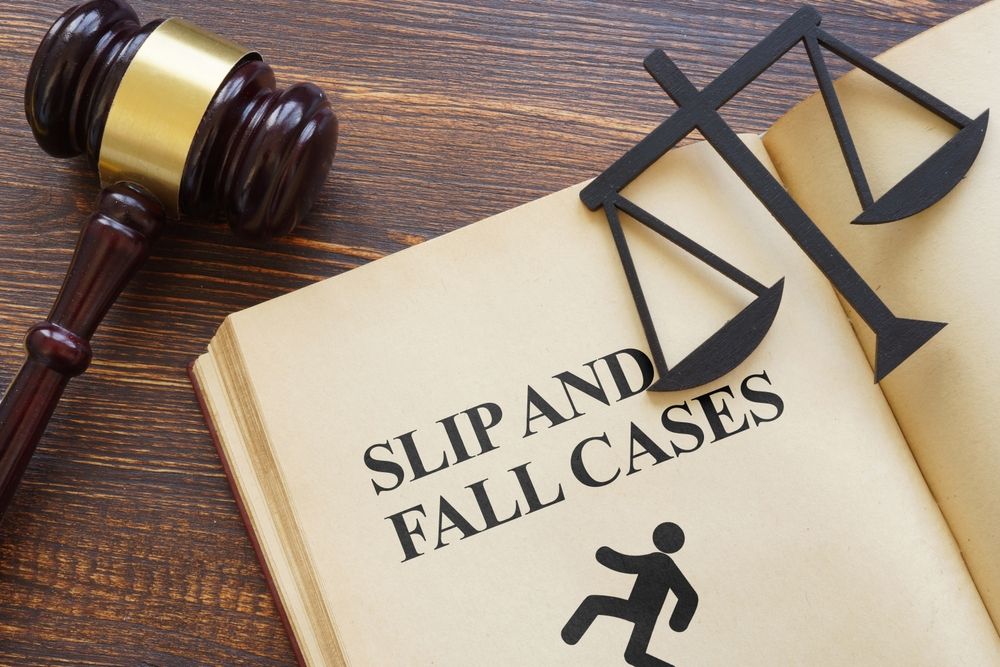 Legal gavel and scales of justice resting on an open law book titled "Slip and Fall Cases," representing personal injury litigation in Florida.
