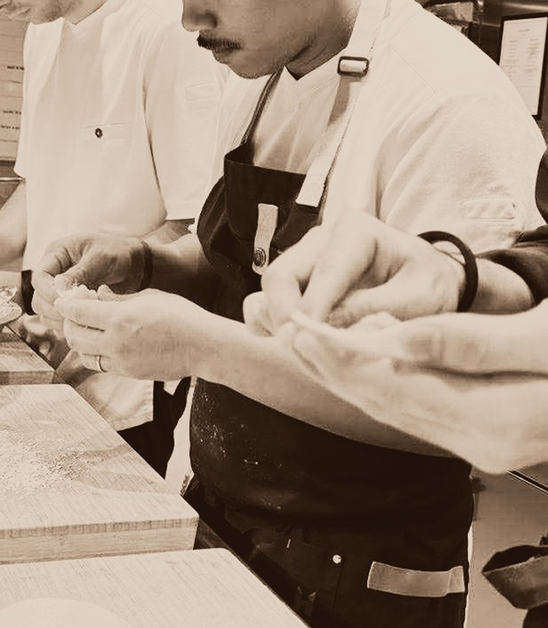 Chef shaping food by hand in the galley