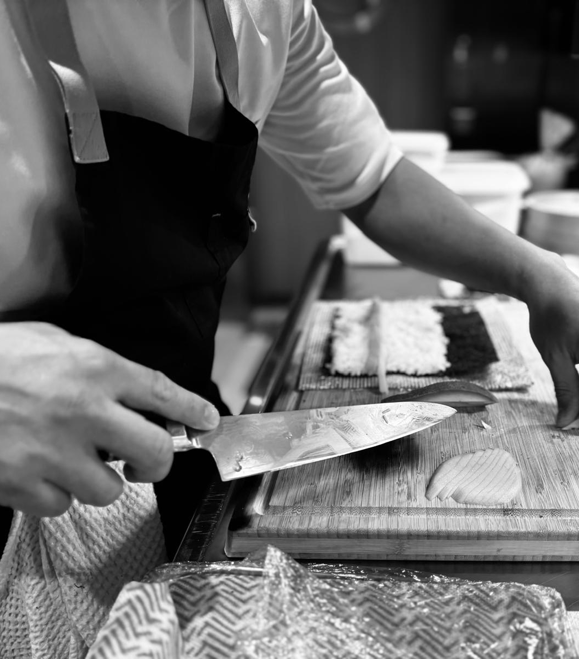 Chef slicing fish on a cutting board