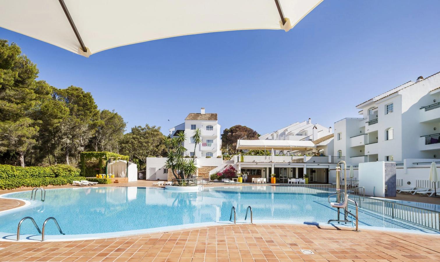 Hotel ILUNION Menorca ligger i Cala Galdana og tilbyder indbydende og moderne ferielejligheder til hele familien.