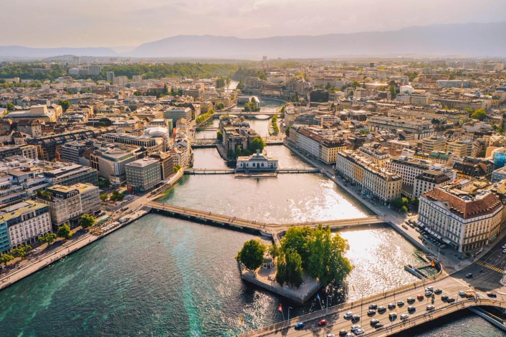Panoramautsikt över gamla stan i Genève med kanaler och bergen i horisonten, Schweiz