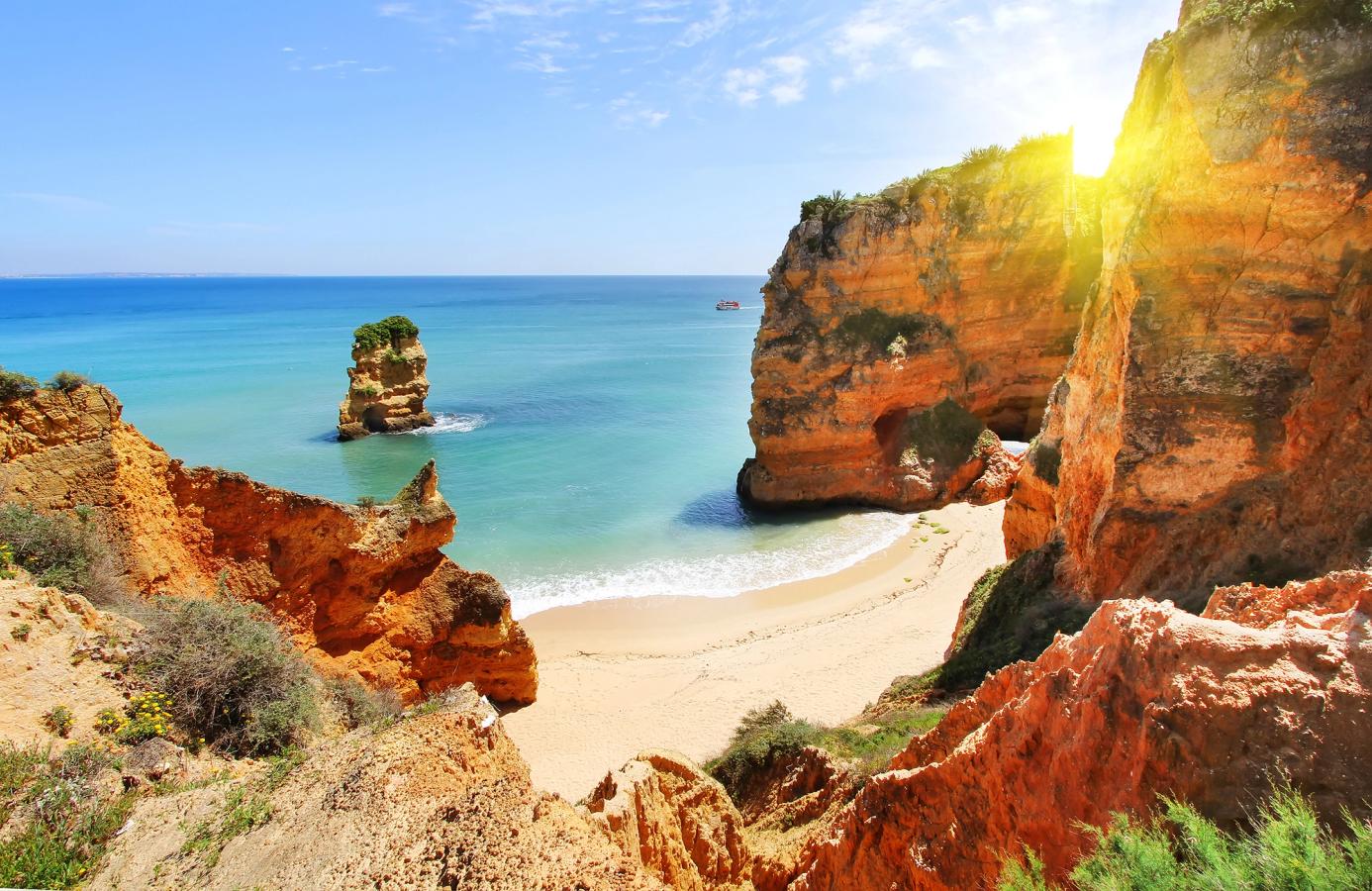Nydelig solnedgang over havet, klippene og stranden i Lagos på Algarvekysten