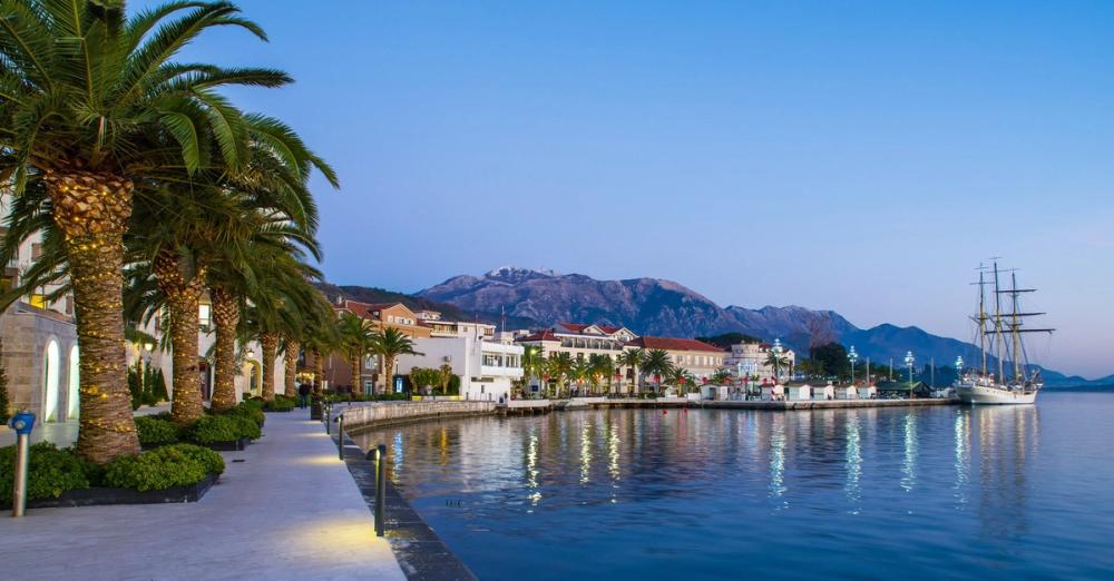 Havnepromenaden i Tivat er idyllisk i kveldslys med utsikt til sjø og fjell