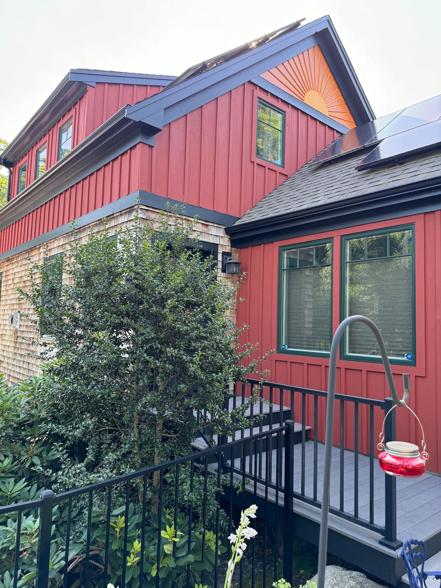 Nelson Painting is a local house-painting business that provides exterior house painting, shown here after a siding vertical red front project
