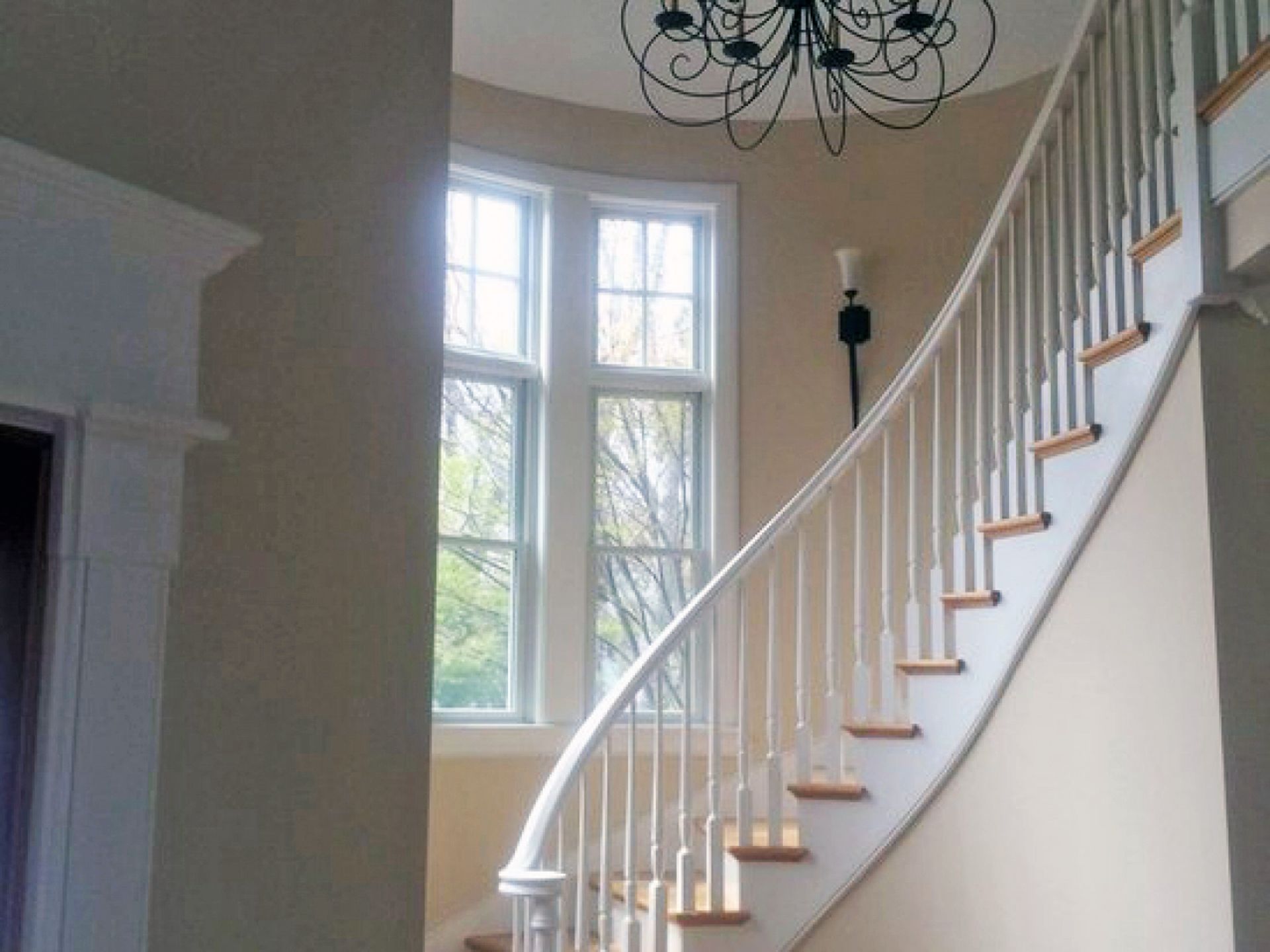 Nelson Painting is a painting contractor that provides interior painting, shown here after a curved staircase foyer chandelier project