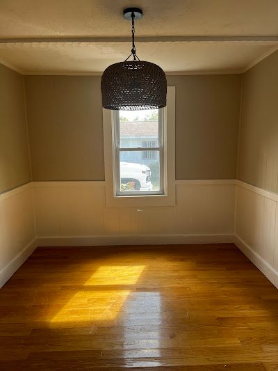 Nelson Painting is a painting contractor that provides interior painting, shown here after a dining room beige walls wainscoting project
