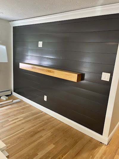 Nelson Painting is a third-generation painting business that provides interior painting, shown here after a accent wall dark shiplap floating shelf project