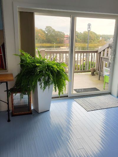 Nelson Painting is a family-owned painting business that provides interior painting, shown here after a painted floor blue sunroom deck view project