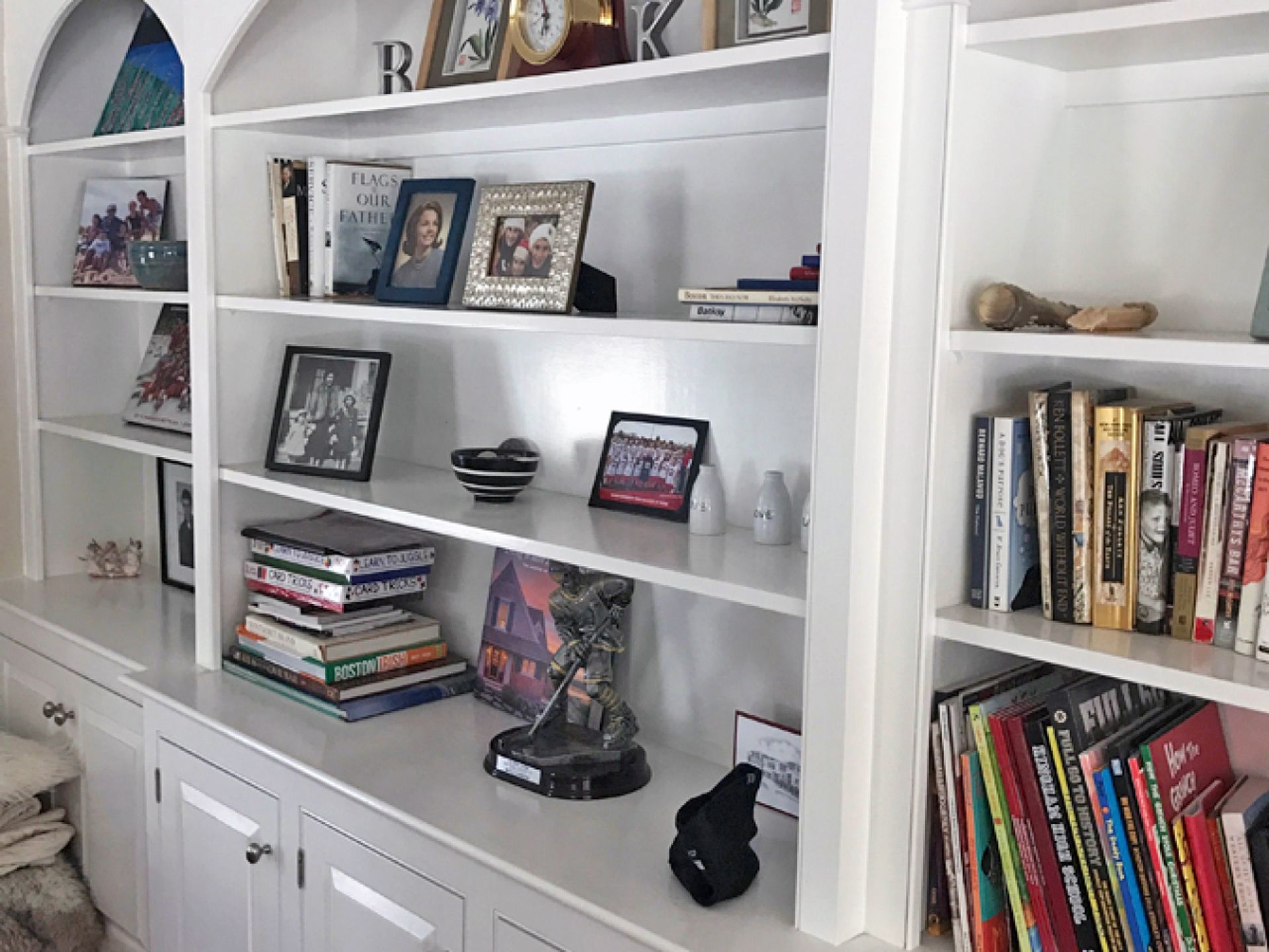 Nelson Painting is a painting contractor that provides cabinet refinishing and kitchen cabinet painting, shown here after a built in shelving white project