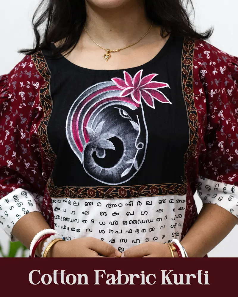 Woman wearing cotton kurti with Malayalam character print, puff sleeves, side pocket, thread work, and hand-painted yoke design – SutiSaaj.