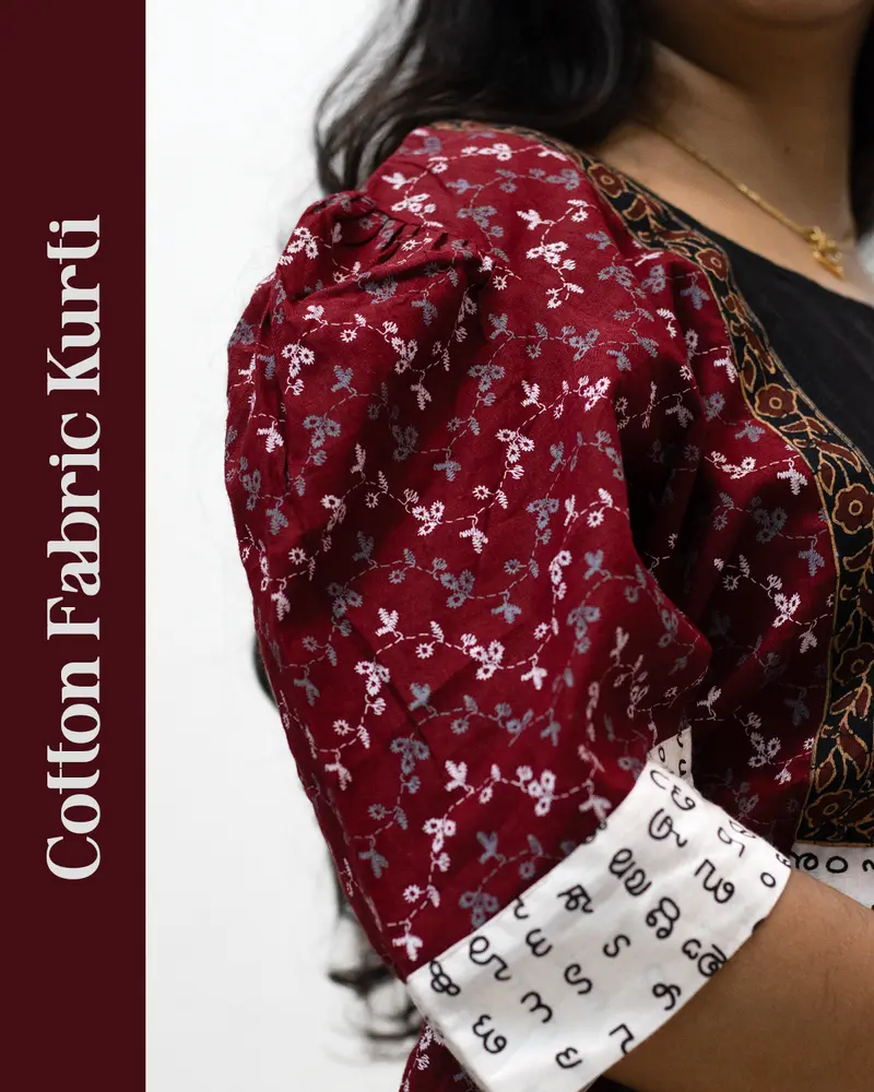 Woman wearing cotton kurti with Malayalam character print, puff sleeves, side pocket, thread work, and hand-painted yoke design – SutiSaaj.
