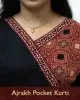 Woman wearing black pure cotton Angrakha kurti with Ajrakh block print, designed cuffs, side pocket, and decorative front buttoned pocket – SutiSaaj.
