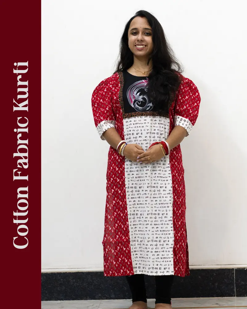 Woman wearing cotton kurti with Malayalam character print, puff sleeves, side pocket, thread work, and hand-painted yoke design – SutiSaaj.