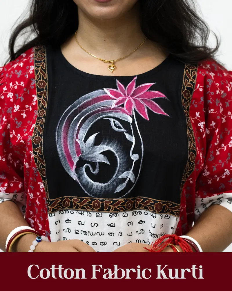Woman wearing cotton kurti with Malayalam character print, puff sleeves, side pocket, thread work, and hand-painted yoke design – SutiSaaj.