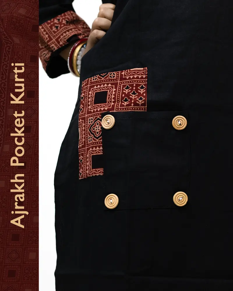 Woman wearing black pure cotton Angrakha kurti with Ajrakh block print, designed cuffs, side pocket, and decorative front buttoned pocket – SutiSaaj.