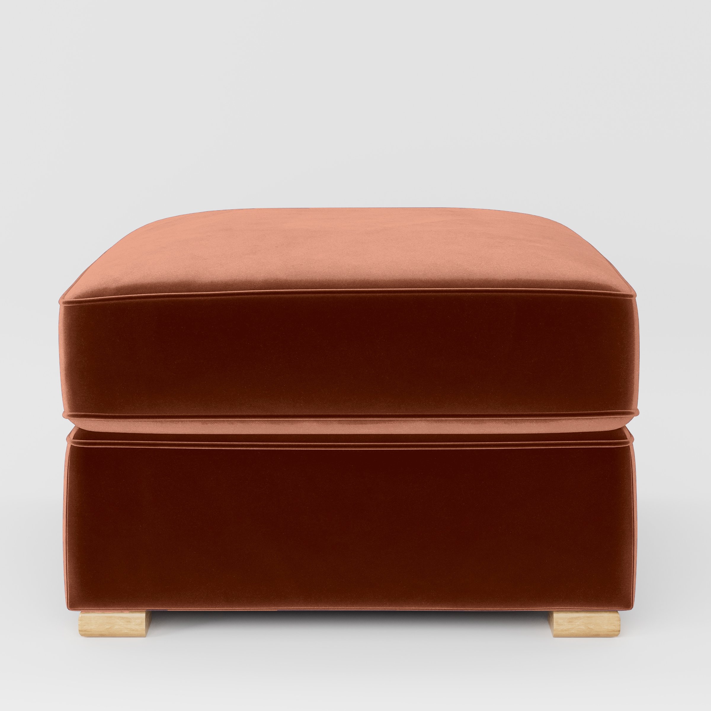 Front view of the Cashel footstool upholstered in Plush EasyClean Velvet in Apricot.