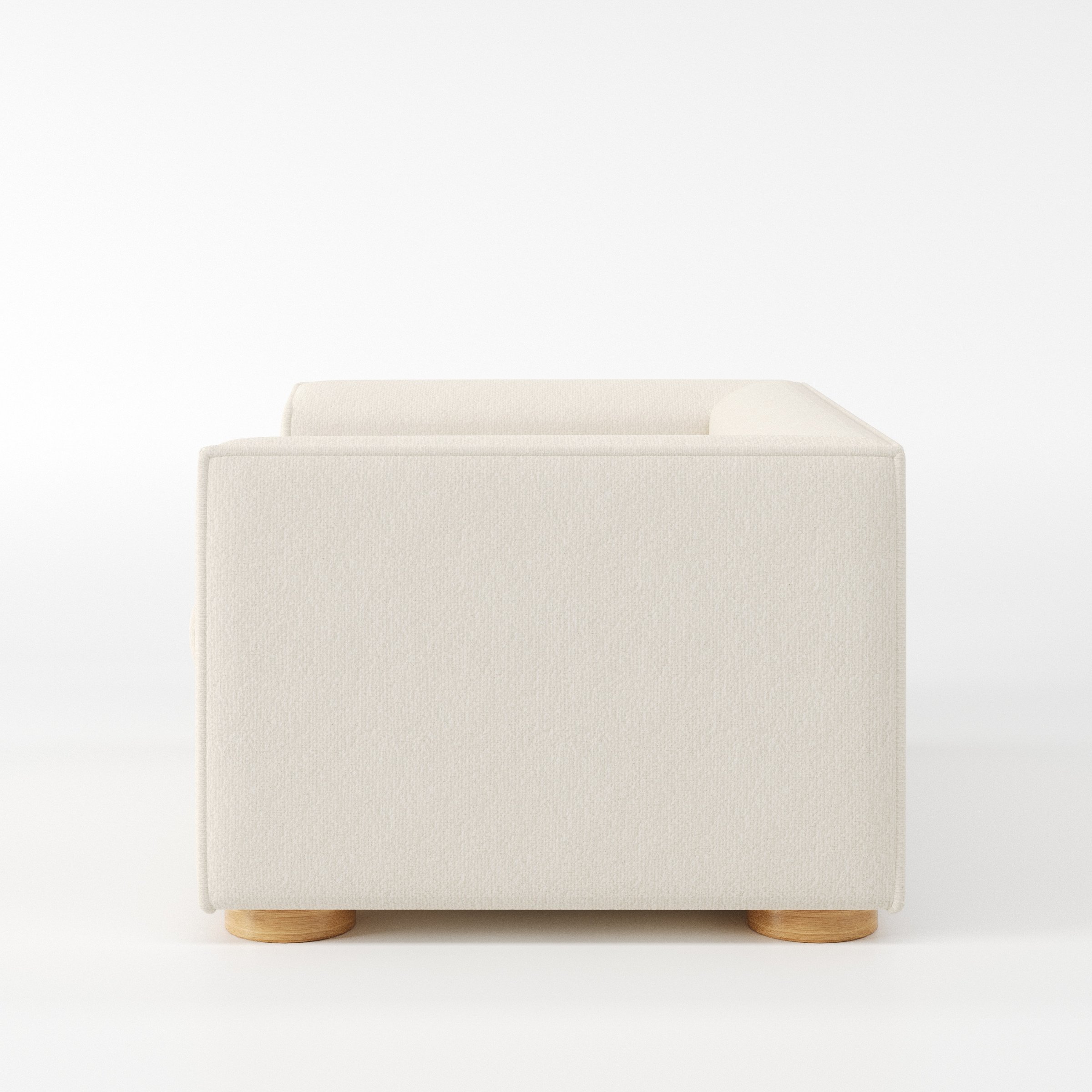 Feale armchair in Kilda Boucle Cream shown in side profile displaying proportions and overall silhouette.