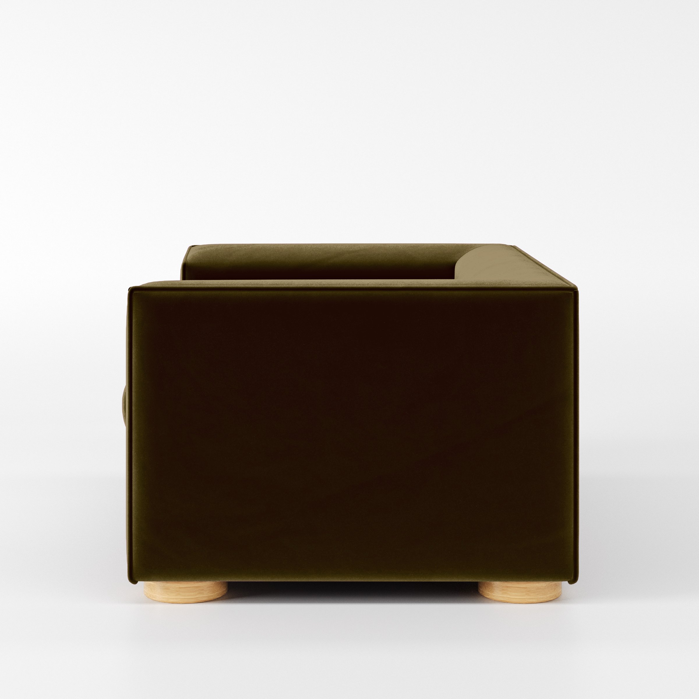 Side view of the Feale armchair upholstered in Plush EasyClean Velvet in Cedar.