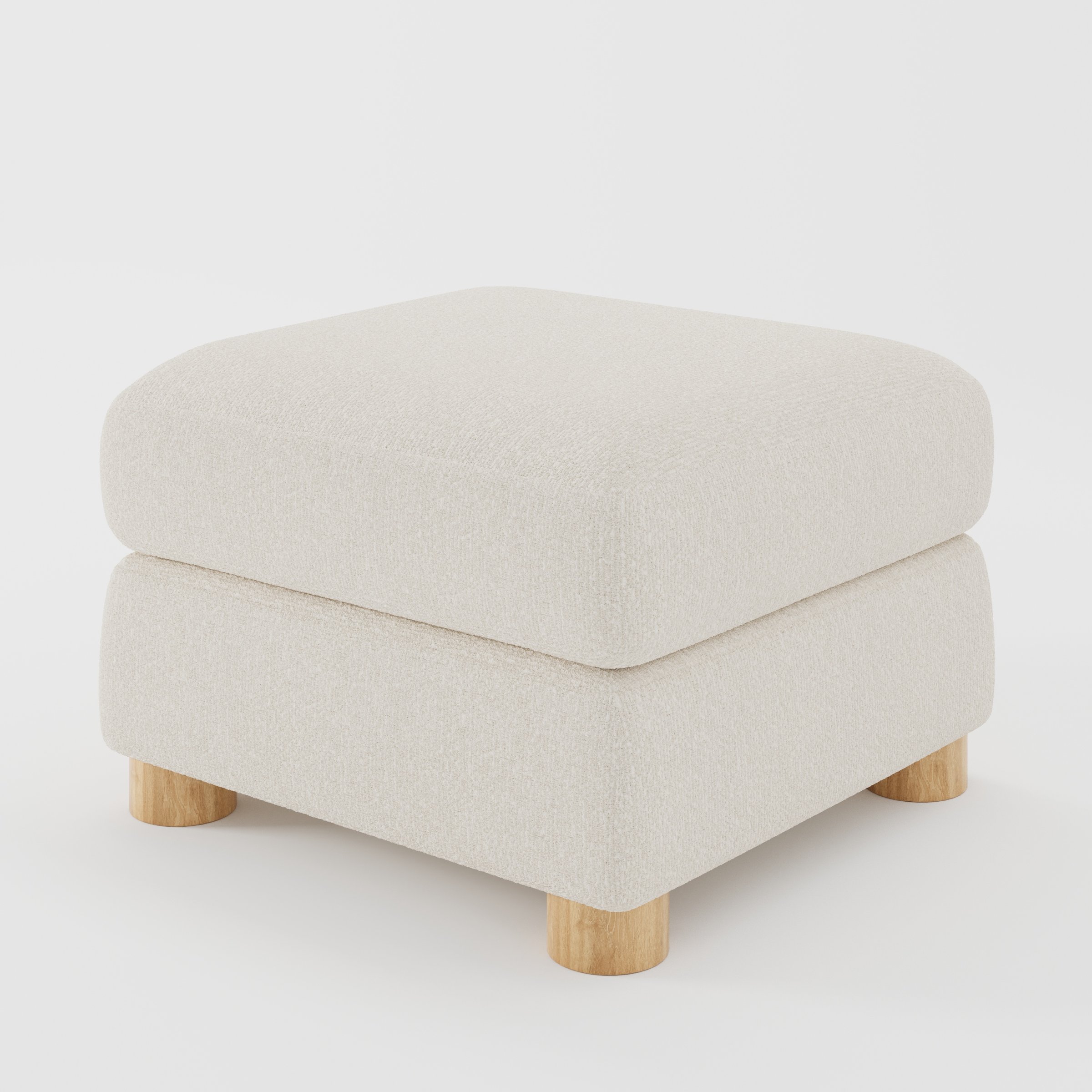 Windermere footstool in Kilda Boucle Cream shown at a diagonal angle highlighting soft corners and rounded wooden feet.
