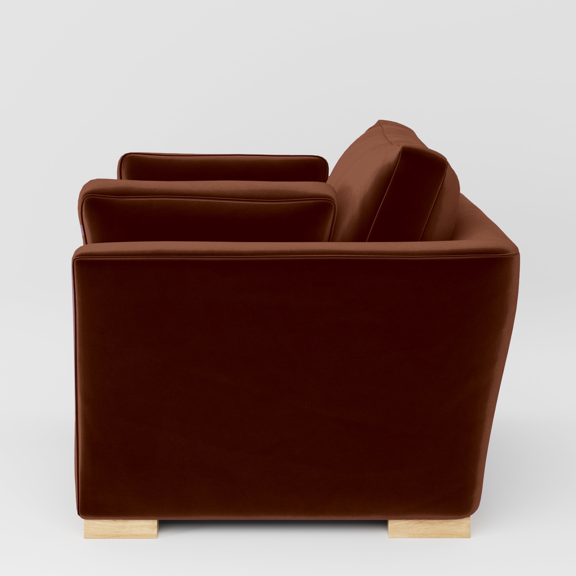 Side view of the Stowe armchair upholstered in Plush EasyClean Velvet in Maple.