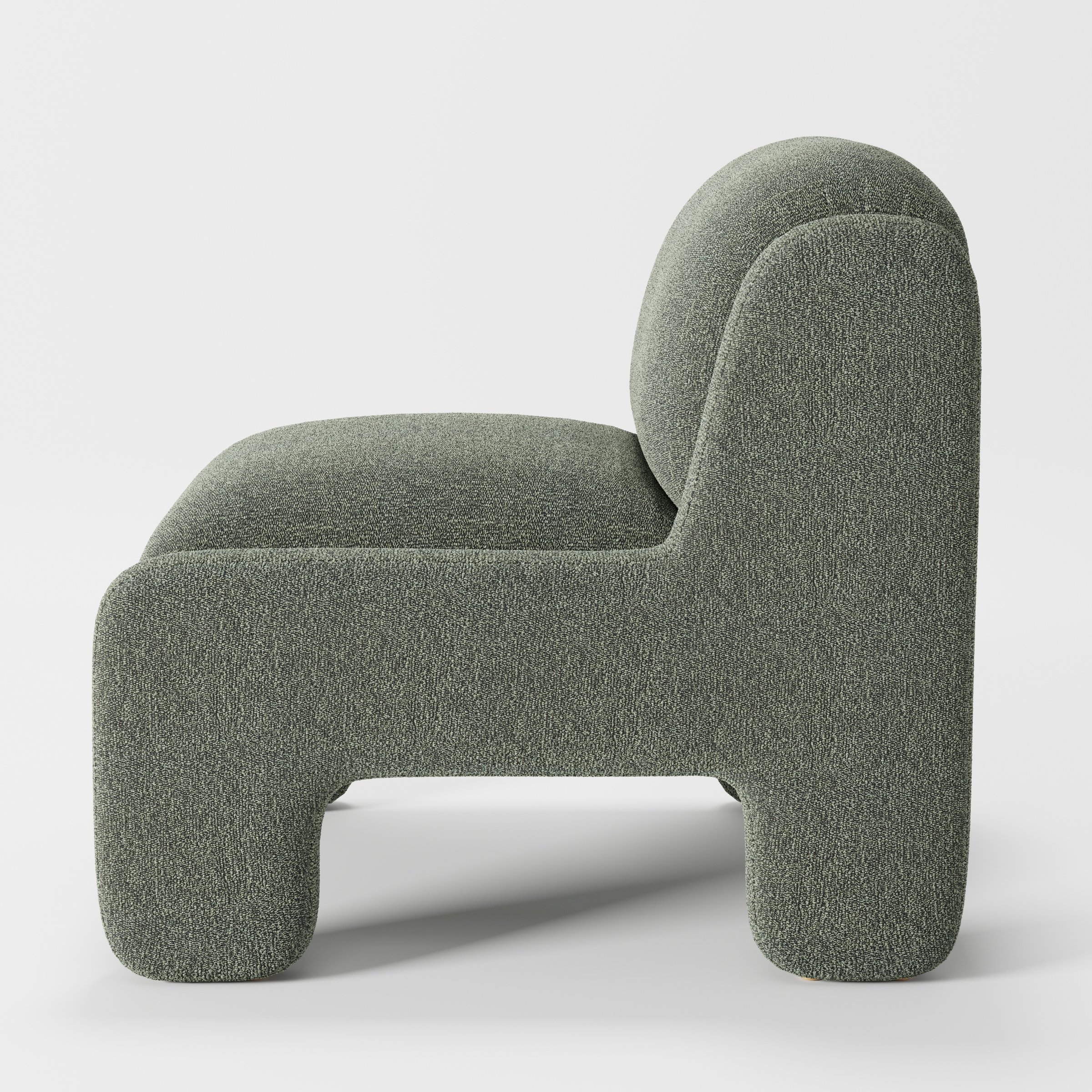 Inny armchair in Kilda Boucle Moss shown in side profile displaying proportions and overall silhouette.