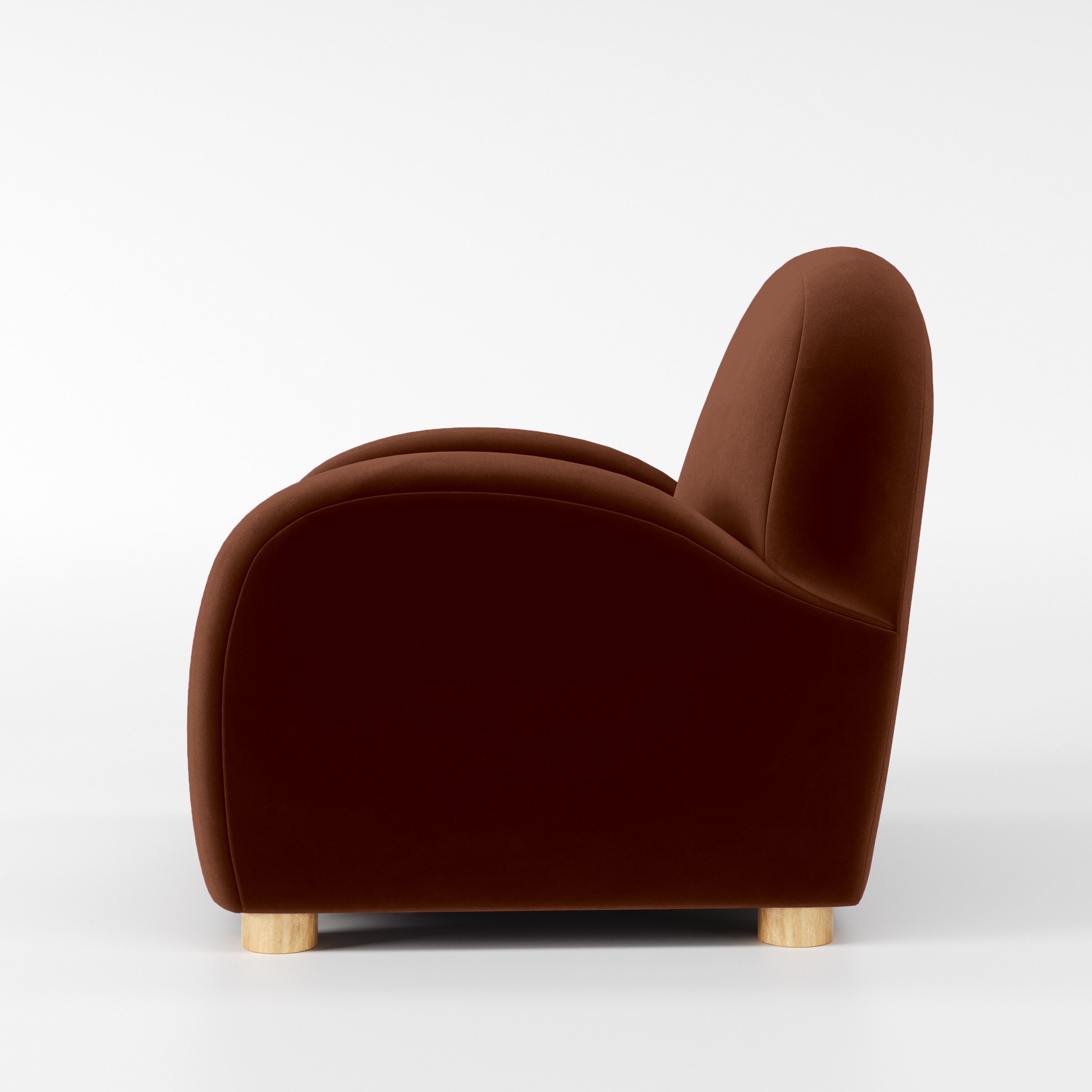 Side view of the Awe armchair upholstered in Plush EasyClean Velvet in Maple.