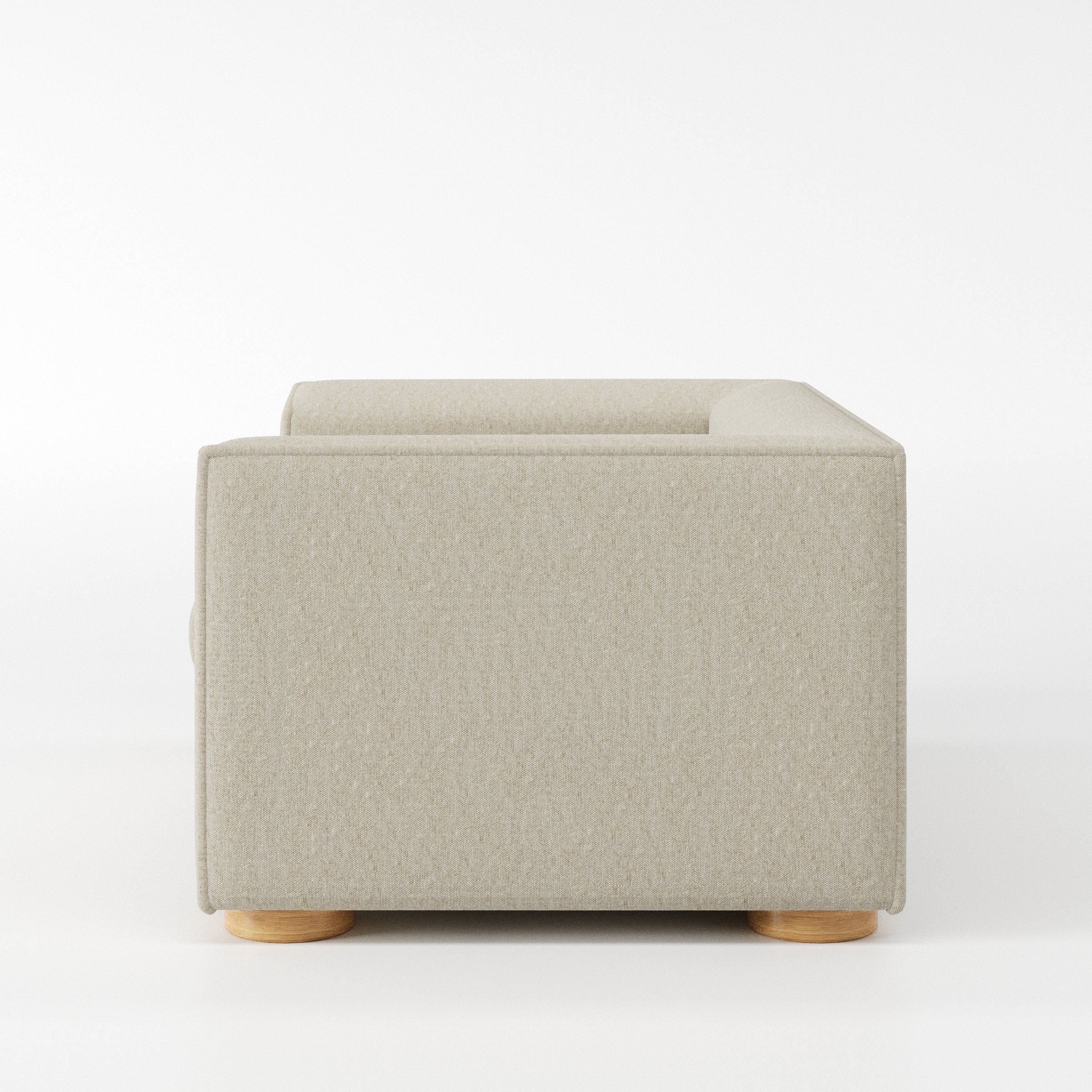 Feale armchair in Alderney Linen Oatmeal shown in side profile displaying proportions and overall silhouette.