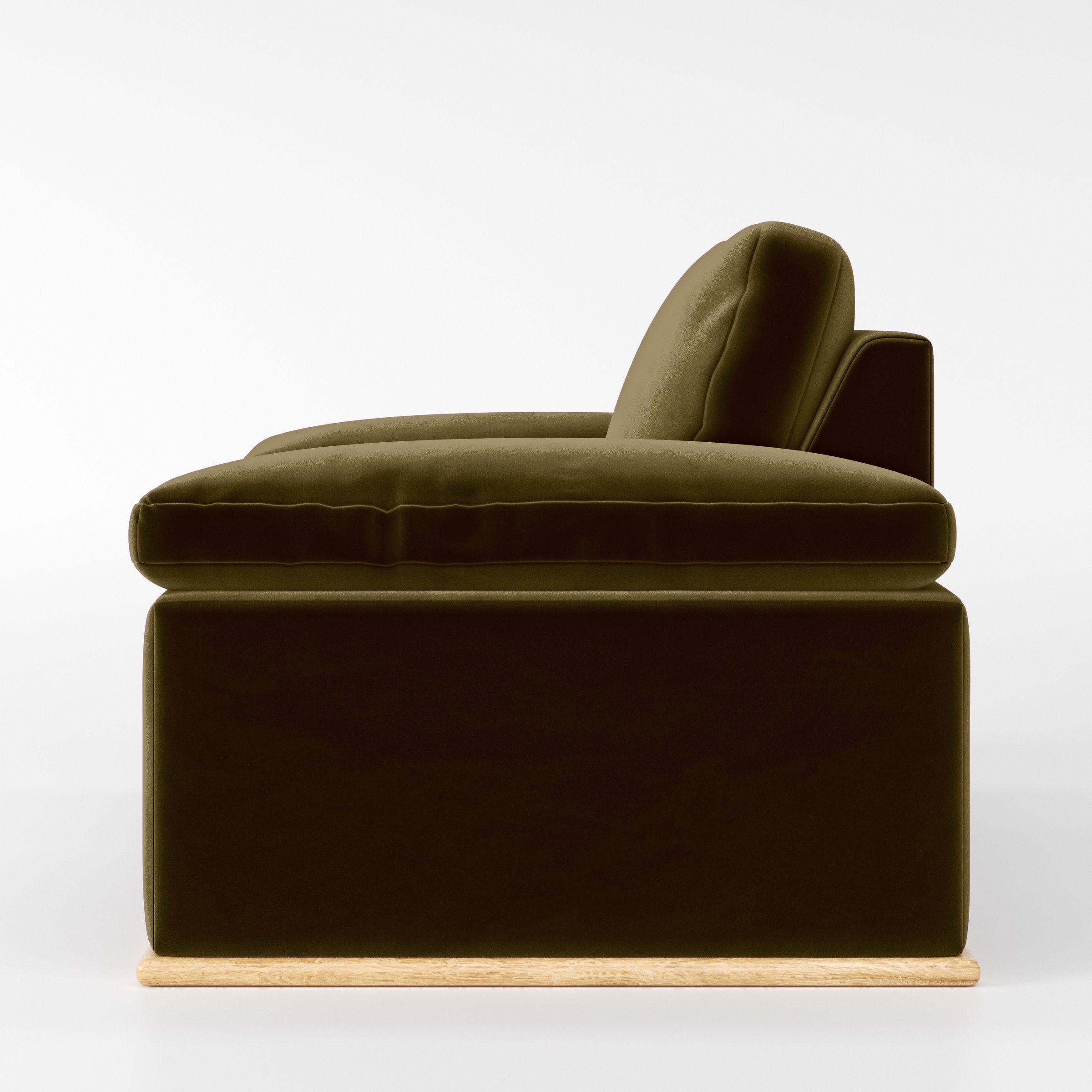 Side view of the Cusher armchair upholstered in Plush EasyClean Velvet in Cedar.