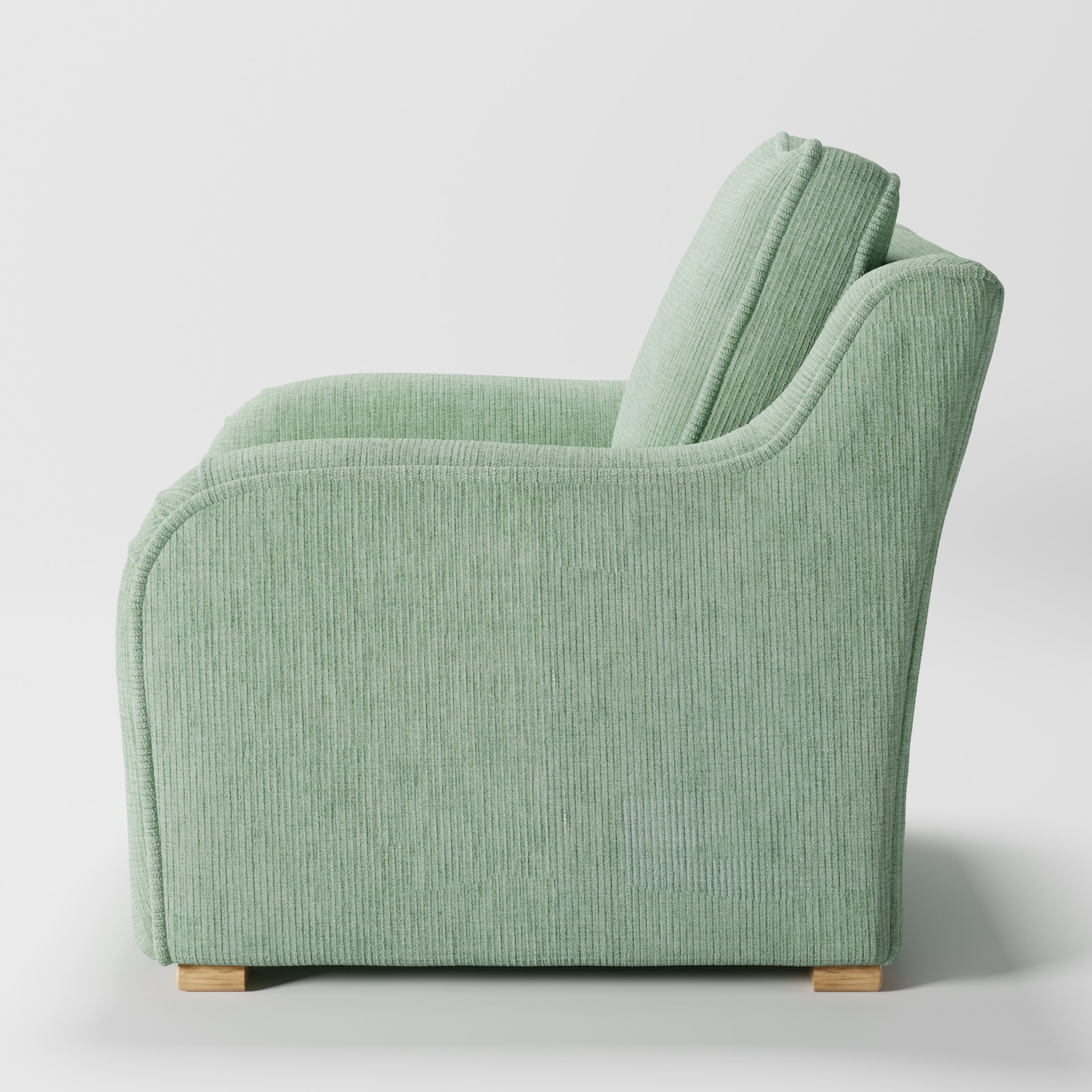 Cashel armchair in Caldey Velvet Corduroy Eucalyptus shown in side profile displaying proportions and overall silhouette.
