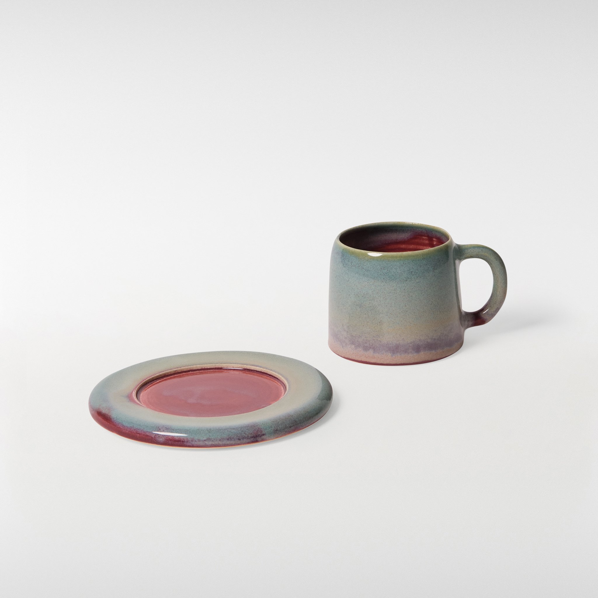 Loam glazed ceramic cup and saucer set, cup and saucer shown separately highlighting soft curves and tonal glaze variation